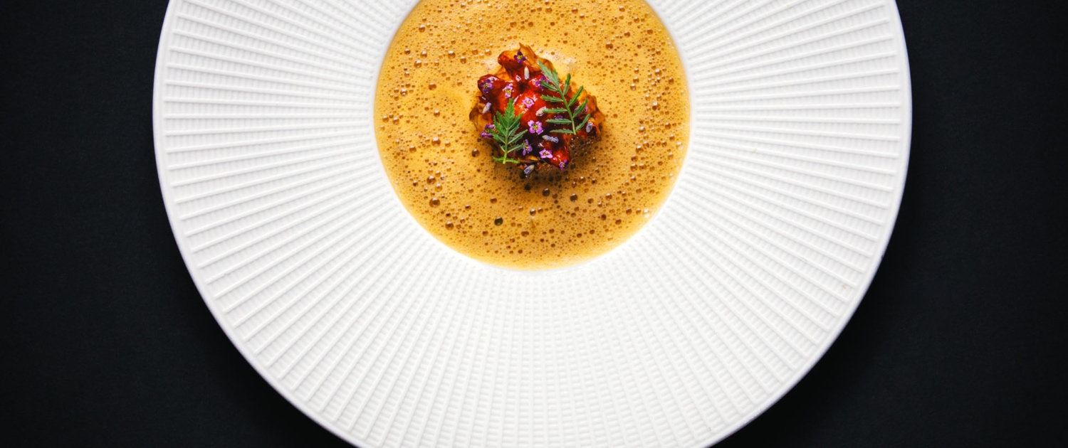 EUROPEAN LOBSTER - L’Américaine, lavender, nashi pear, crispy potato. A dish on a big white plate at 2 Michelin star Restaurant Vinkeles, in luxury boutique hotel The Dylan Amsterdam.
