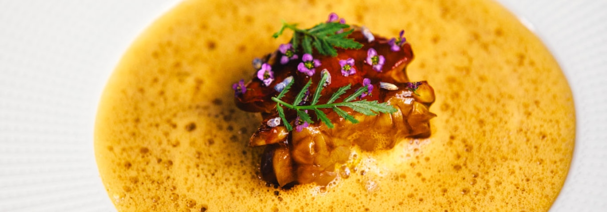 EUROPEAN LOBSTER - L’Américaine, lavender, nashi pear, crispy potato. A dish on a big white plate at 2 Michelin star Restaurant Vinkeles, in luxury boutique hotel The Dylan Amsterdam.